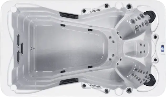 Top-down view of the Aquaflow, a large rectangular white swim spa with multiple seats, jets, steps, and a spacious central area for relaxing—even in Abu Dhabi’s heat when used with a chiller. Convenient controls are located on the right side.